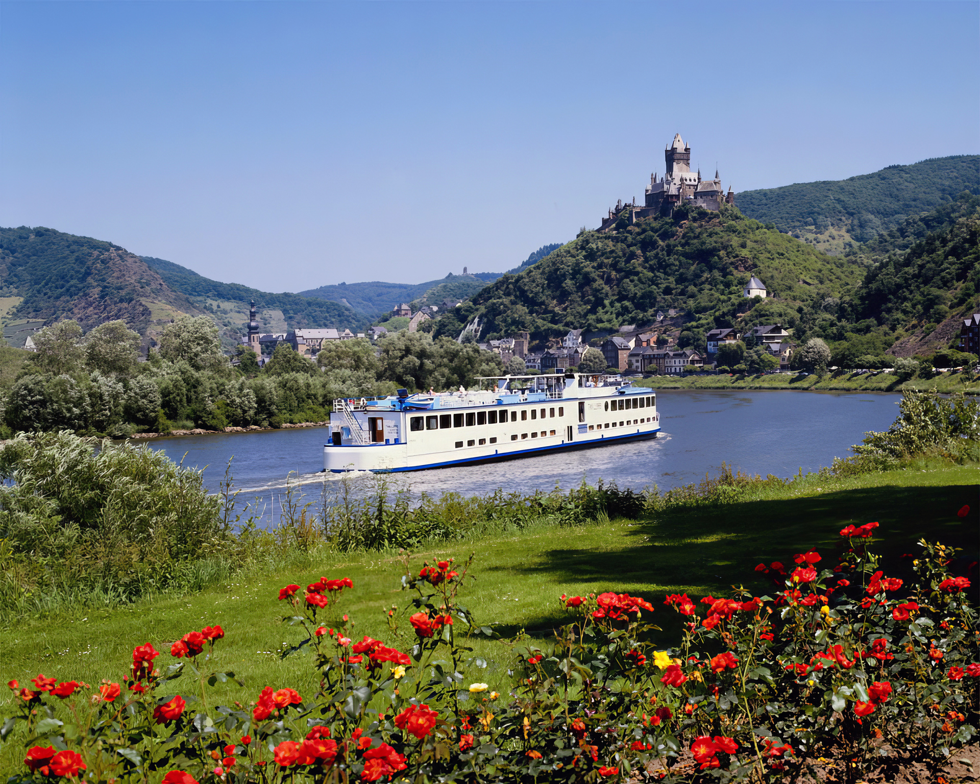 Scenic Landscape With Flower Water And Boat Near Mountains